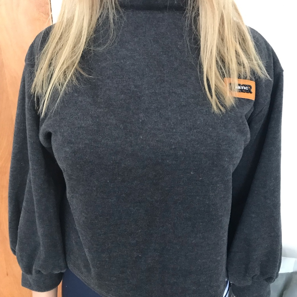 A grey turtleneck shirt